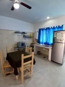 a kitchen with a table and a refrigerator and a counter at Linda Goya in Goya