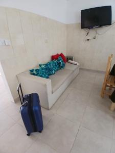 a living room with a couch and a suitcase at Linda Goya in Goya