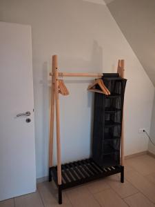 a wooden shelf in a room with a closet at Strandrose in Friedrichskoog