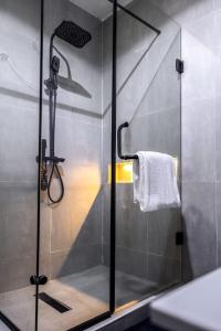 a shower with a glass door in a bathroom at Eterniti by Amber in Lagos +56 photos