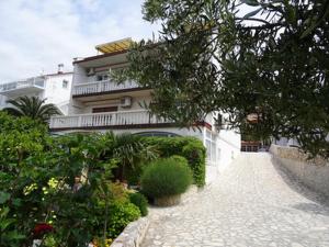 a white building with a walkway in front of it at Little villa Tony- Center 40m beach Crikvenica in Crikvenica