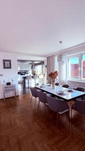 a dining room and living room with a table and chairs at Panorama Apartment in Nowy Targ