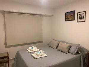 a bedroom with two towels on a bed at Namante in Balcarce
