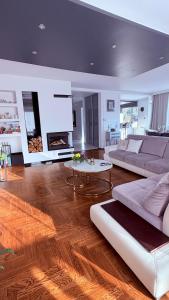 a living room with a couch and a table at Panorama Apartment in Nowy Targ