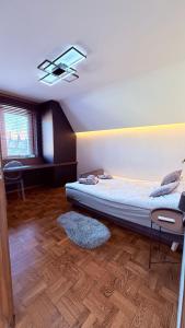 a bedroom with a bed and a ceiling at Panorama Apartment in Nowy Targ