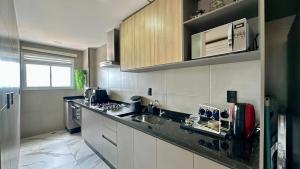 a kitchen with a sink and a counter top at Studio Red 10 - Sorocaba in Sorocaba +12 photos