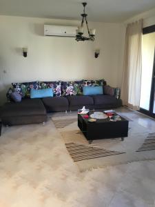 a living room with a couch and a coffee table at Villa at Marassi - Verona in El Alamein