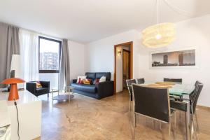 a living room with a table and a dining room at Picasso Suites in Barcelona