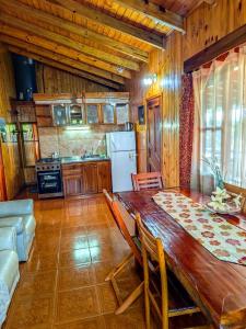 a kitchen with a wooden table in a room at Riberas del Parana in Wanda