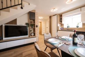a dining room with a table and a television at Hidden Oasis - pool, playground - 3 min from the beach in Vir +30 photos