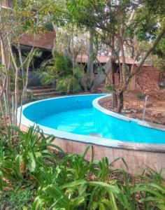 a swimming pool in a garden with trees at Hacienda Cordova in San Sebastián Etla