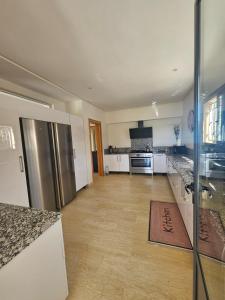 a large kitchen with a stainless steel refrigerator at Villa in Aït Bou Zguia