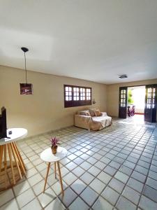 a room with a bed and two tables in it at Casa com piscina em Aldeia in Camaragibe