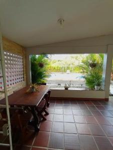 an empty patio with a table and potted plants at Casa com piscina em Aldeia in Camaragibe