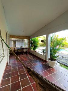 a porch with a hammock in a house at Casa com piscina em Aldeia in Camaragibe