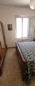 a bedroom with a bed and two windows at Casamare in Roseto degli Abruzzi