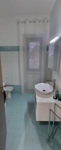 a bathroom with a tub and a sink and a toilet at Casetta Mena in Sulmona +22 photos