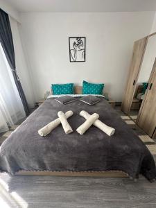 a bed with three wooden crosses on it at AKY Residence in Slănic-Moldova