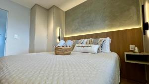 a bedroom with a large bed with a basket on it at Studio Red 12 - Sorocaba in Sorocaba
