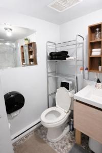a bathroom with a toilet and a sink at Le Cube in Drummondville