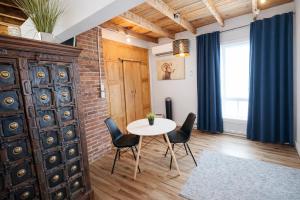 a dining room with a table and chairs and a brick wall at Le Cube in Drummondville