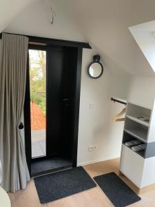 a room with a black door and a window at Aplusstudio in Zottegem