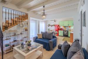 a living room with a blue couch and a table at Villa Christalia in Kolymbia