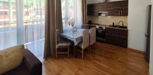 a kitchen with a table and chairs in a room at Serce Suwałk in Suwałki