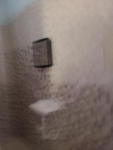 a box on the wall of a bathroom at Recanto do MIMI in Bertioga