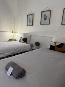 a hotel room with two beds with a price tag on them at Les remparts in Chabeuil