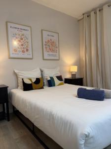 a bedroom with a large white bed with pillows at Les remparts in Chabeuil