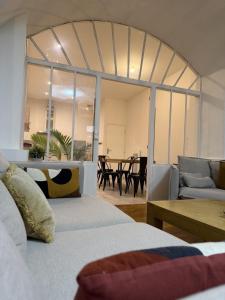 a room with two beds and a living room with a table at Les remparts in Chabeuil