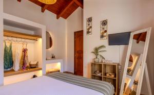 a bedroom with a bed and a tv on the wall at Villa Christalia in Kolymbia +52 photos