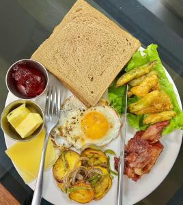 a plate of breakfast food with eggs and toast at Hotel Saraswati in Nautanwa +16 photos