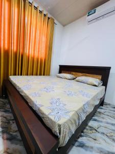 a large bed in a room with a window at Apollo Villa Weligama in Weligama