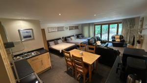 a living room with a couch and a table at Kendall Lodge in Burwell