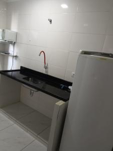 a kitchen with a sink and a refrigerator at Itu Loft Pousada Girassol in Itu +37 photos