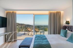 a bedroom with a bed and a balcony with a view at Villa Paulina MOUGINS in Mougins +60 photos