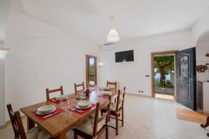 a dining room with a wooden table and chairs at Oasi Milano in Furore