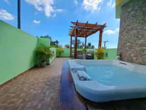 a hot tub on the patio of a house at Hermoso Loft in Santo Domingo