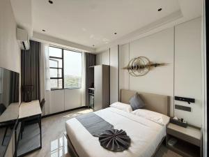 a bedroom with a large bed and a desk at Hotel Eden24 Novembre in Kinshasa +48 photos