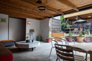 a living room with a table and chairs at Happy House Hostel in Santiago