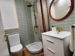 a bathroom with a toilet and a sink and a mirror at Casa ALFANG in Torrent +49 photos