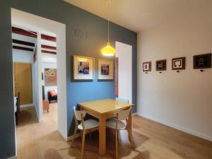 a dining room with a wooden table and chairs at Casa ALFANG in Torrent