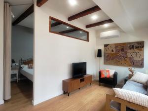 a living room with a tv and a bedroom at Casa ALFANG in Torrent