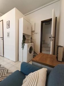 a living room with a couch and a refrigerator at Stan na dan Valjevo Centar in Valjevo