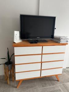 a tv sitting on top of a dresser at Depto temporal in Morón