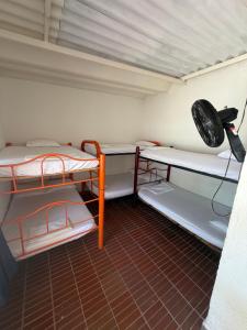 a small room with two bunk beds and a fan at Brisas de melgar in Melgar
