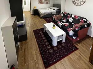 a living room with a couch and a coffee table at Sošice Garden Apartments in Sošice