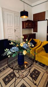 a living room with a vase of flowers on a table at CpB3 in Bratislava